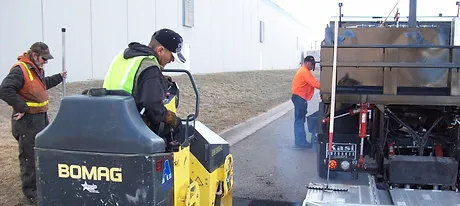 Road Builders Using Asphalt Paving Machine - Apex Pavement Solutions