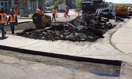 Road Builders Destroying Damaged Asphalt - Apex Pavement Solutions